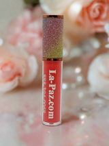 Lip gloss with glittery cap on a floral background