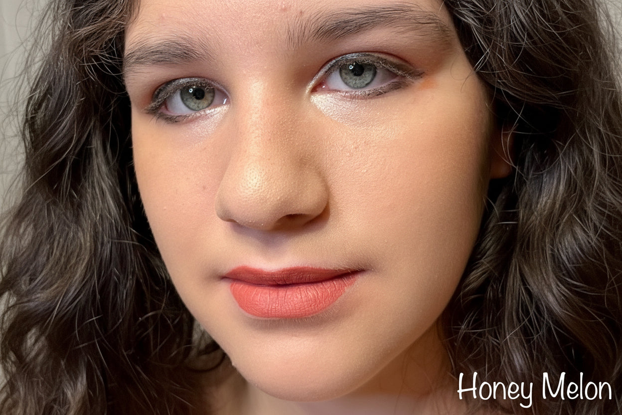 Close-up of a person with wavy hair and  'Honey Melon' lipstick