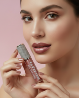 Woman holding Goddess metallic matte liquid lipstick  with a pink background