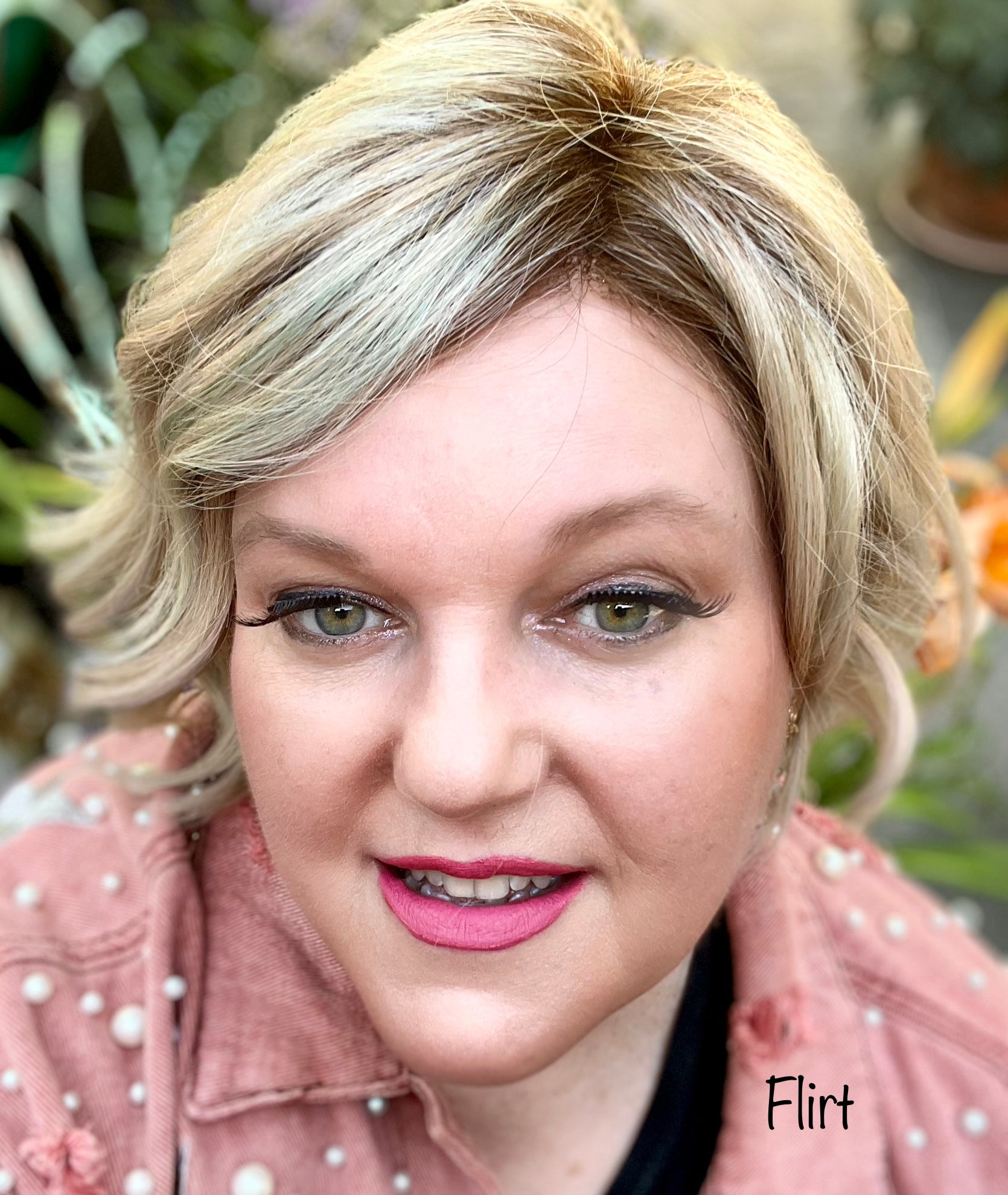 pink flirt lipstick on woman in pink jacket