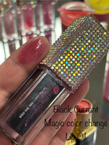 Black lip oil shown beside a swatch of the color changing oil on a fingertip