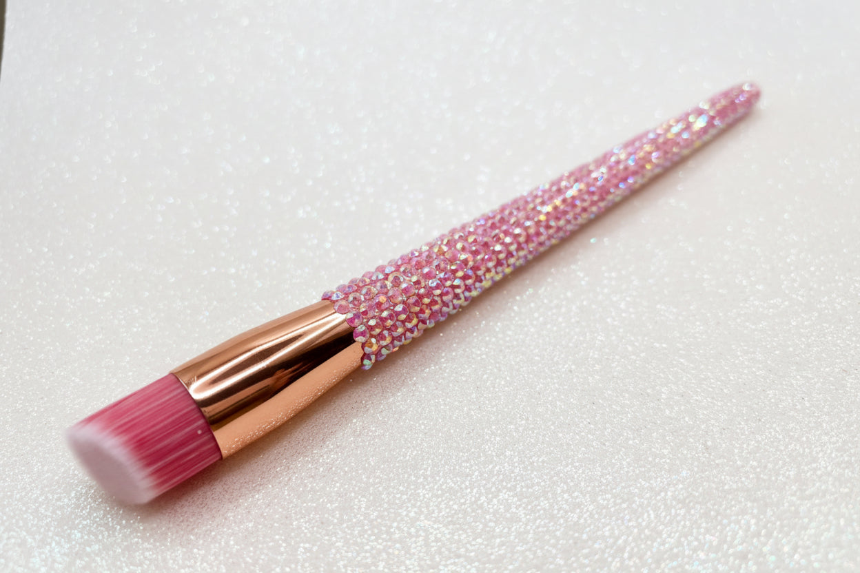 Stippling Makeup brush with pink bristles and a pink rhinestone handle on a sparkly background by La Paz Cosmetics