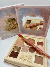 Makeup palette with brush and decorative box on a white background