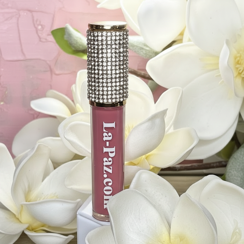 Pink matte lipstick in color Flirt with rhinestone top and white flowers