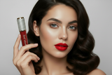 Woman holding a red lip gloss with a gray background