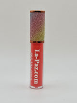 Lip gloss with glittery cap and peach body displaying 'La-Paz.com' on a white background