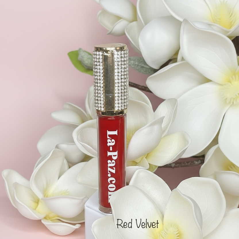 Red lipstick with 'La Paz' branding with white flowers against a pink background