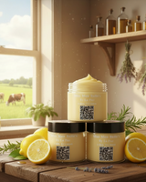 Jars of lemon face balm on a wooden table with lemons and herbs, window view of cows in a field.