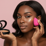 Woman applying makeup with a compact and pink sponge on a pink background