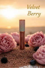 La Paz Cosmetics Velvet Berry Lux Lip Gloss S28 — sheer brown berry gloss with holographic rainbow glitter cap with a sunset background