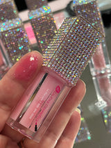 Mercury lip oil with a swatch of mercury lip oil on the tip of a finger