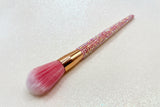 Powder Makeup brush with pink bristles and a pink rhinestone handle on a sparkly background by La Paz Cosmetics