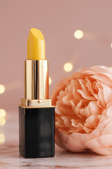 L'Paige Yellow Lemondrop Lipstick that color changes presented by La Paz Cosmetics and styled with a peach peony