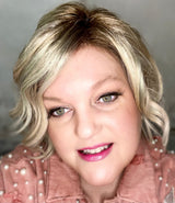 La Paz Cosmetics founder wearing #102 pink coconut color changing lipstick and a pink denim jacket