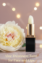 An Aloe Treatment Stick #28 in a  lipstick tube stands beside a large pale cream flower