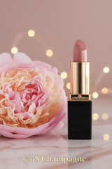 A tube of L'Paige lipstick in shade #38 Champagne with a gold cap, displayed against a mauve