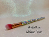 Angled Eye Makeup brush with a full aurora crystal handle, gold ferrule and pink bristles by La Paz Cosmetics on a white background 