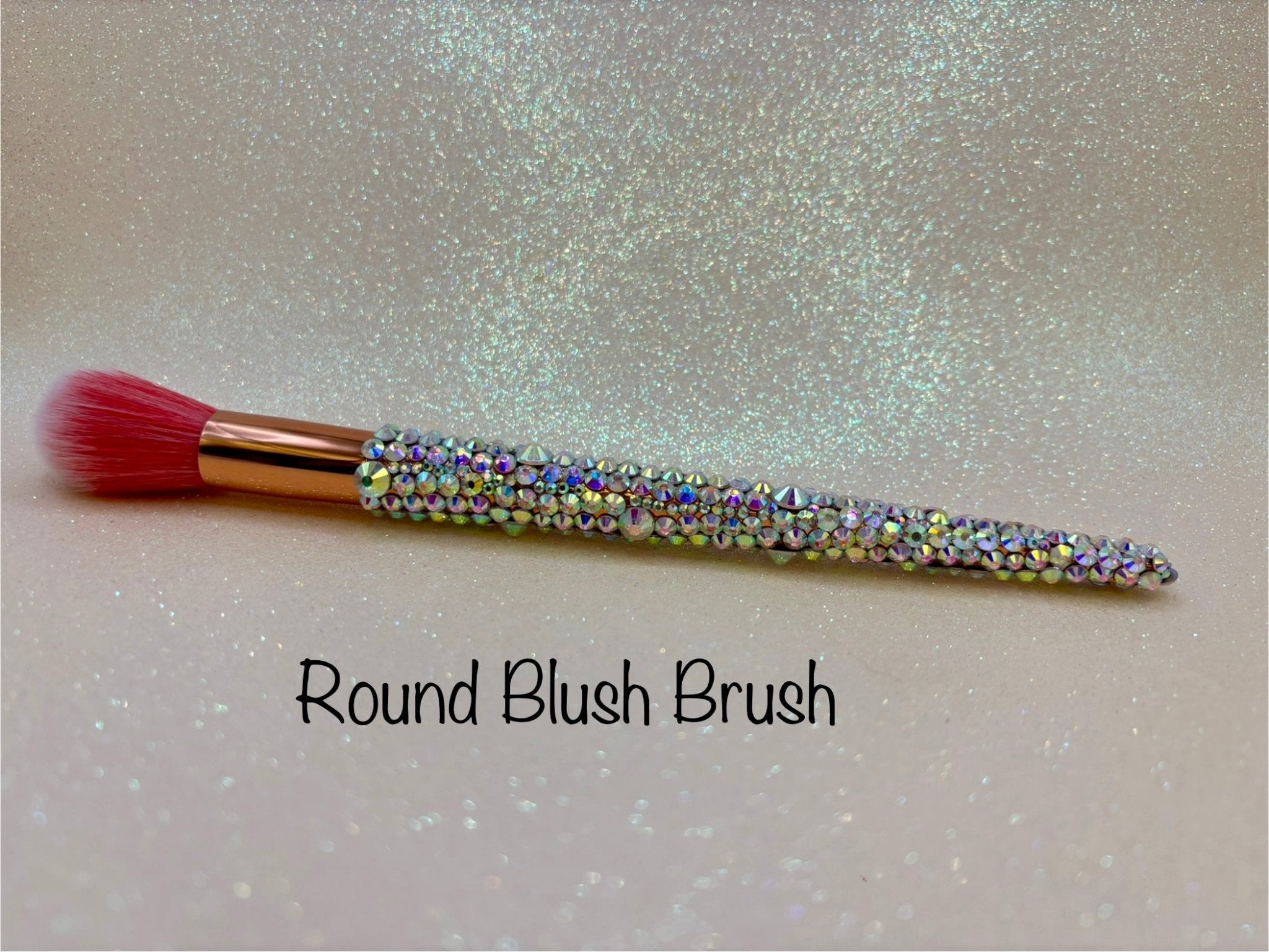 Round Blush Brush with a full aurora crystal handle, gold ferrule and pink bristles by La Paz Cosmetics on a white background 