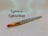 Eyeliner or eyebrow brush with a full aurora crystal handle, gold ferrule and pink bristles by La Paz Cosmetics on a white background 