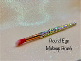 Round Eye Makeup Brush with a full aurora crystal handle, gold ferrule and pink bristles by La Paz Cosmetics on a white background 