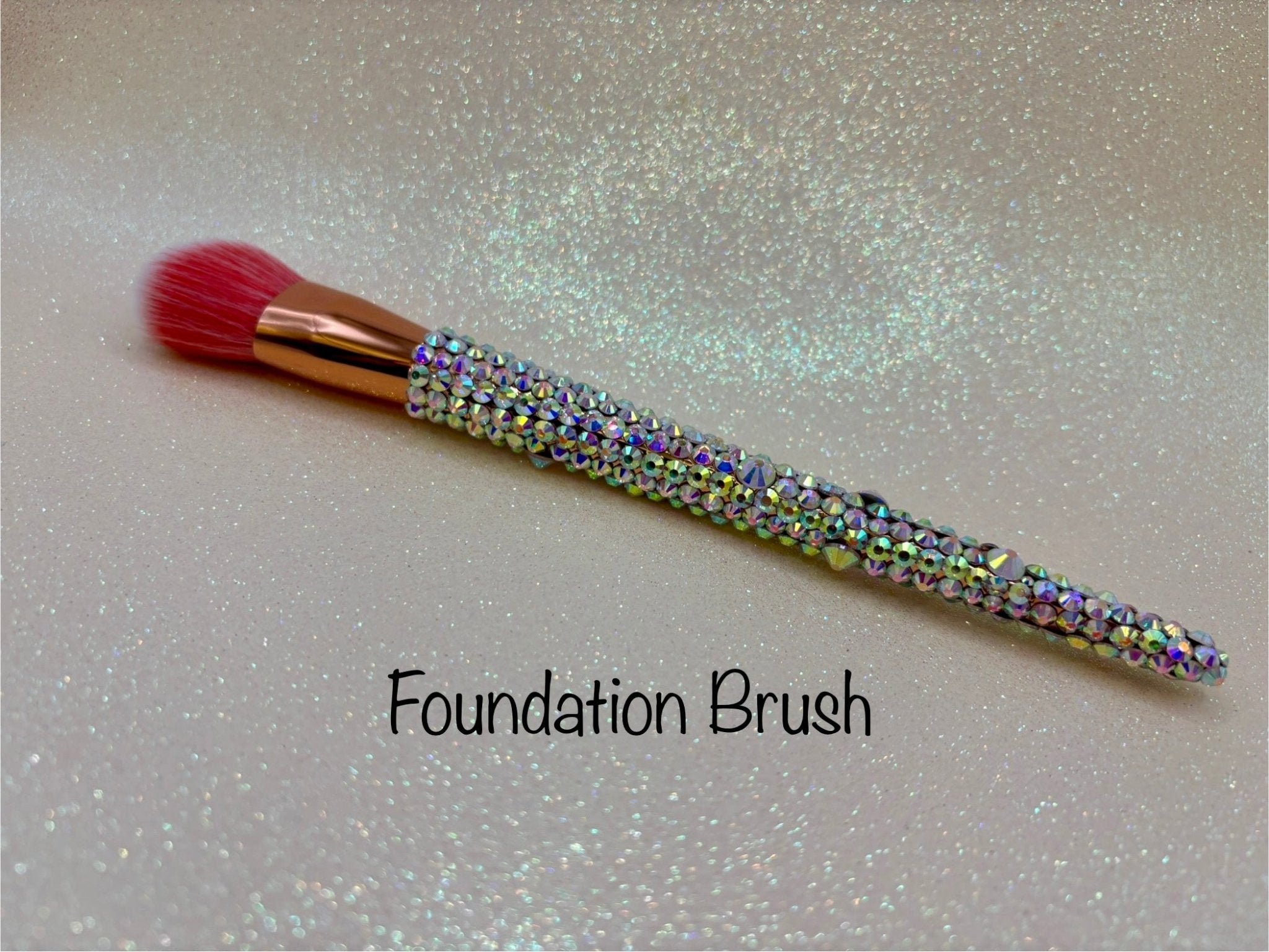 Foundation Brush with a full aurora crystal handle, gold ferrule and pink bristles by La Paz Cosmetics on a white background 