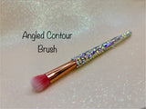 Angled contour brush with a full aurora crystal handle, gold ferrule and pink bristles by La Paz Cosmetics on a white background 