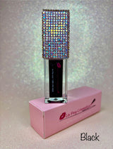 Black lip oil sitting on a pink box with a shimmering background