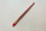 flat eyeshadow application brush 
makeup brush with pink bristles and a pink rhinestone handle on a sparkly background by La Paz Cosmetics
