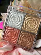A floral shimmer highlighting quad with four shades: white, gold, rose, and bronze, displayed with flowers
