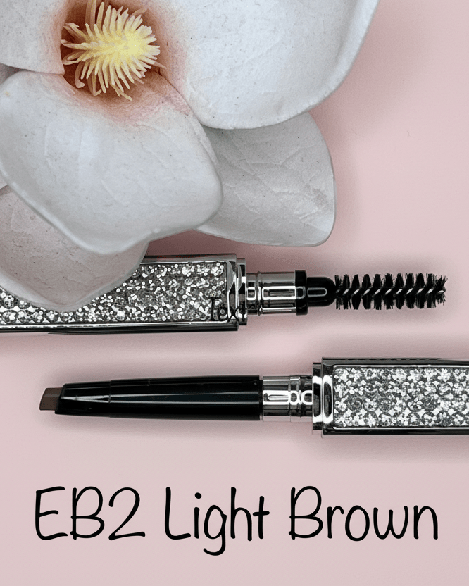 La Paz Cosmetics Luxe Crystal Eyebrow Pencil EB2 Light Brown/Blond open showing dual-ended design with spoolie and precision tip, crystal case on pink background with white orchid