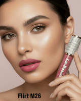 Model with dark hair holding La Paz M26 Flirt Diamond Liquid Matte Lipstick in warm mauve-pink matte on beige background
