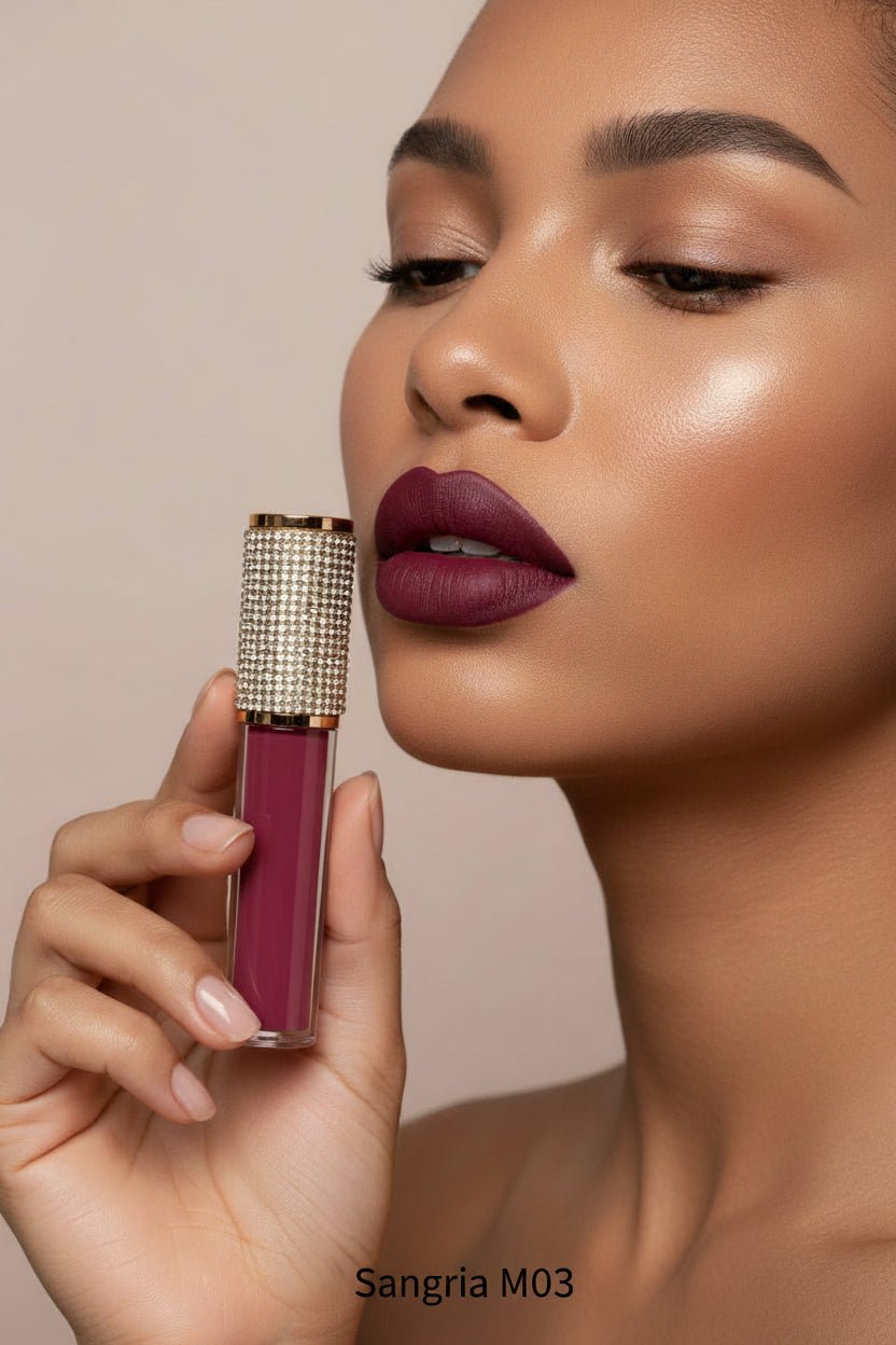 Model with La Paz Cosmetics M03 Sangria Diamond Liquid Matte Lipstick tube with rhinestone cap