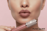 Close-up of lips wearing La Paz Pucker Up Diamond Matte Lipstick, a warm rosy pink matte shade, with rhinestone-capped tube