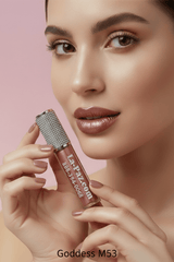 Model holding La Paz M53 Goddess Diamond Liquid Matte Lipstick in warm nude rose shimmer matte on blush pink background