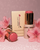 La Paz Cream Blush Stick in Azalea 03 — two gold and soft pink sticks opened showing a vibrant rose pink blush