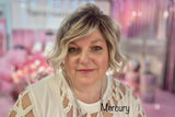 Founder wearing Mercury lip oil With a bokeh Pink background