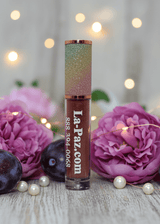 La Paz Plum Delicious Lux Lip Gloss — deep plum gloss with rainbow cap, purple roses, plums & pearl beads with bokeh lights