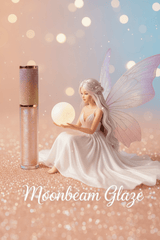 La Paz Moonbeam Glaze Lux Lip Gloss with moon fairy figurine on sparkling surface against soft pastel bokeh background