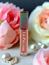 La Paz Sherbet Lux Lip Gloss — peach-coral gloss with rainbow glitter cap, pink roses & pearl beads on marble surface