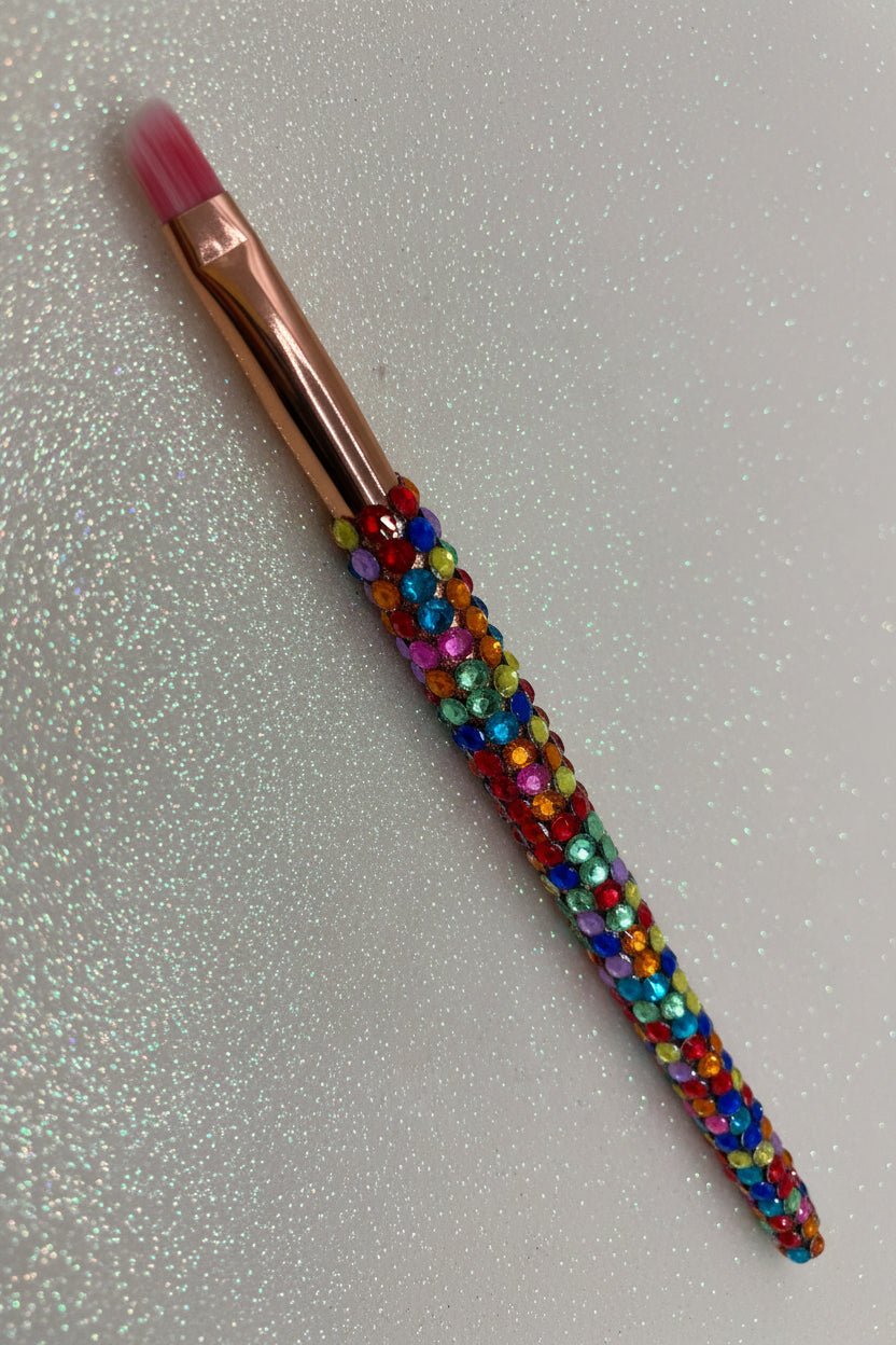 Rainbow  Bling Eye Makeup Angled Contour Brush with a full multicolored crystal handle, gold ferrule and pink bristles by La Paz Cosmetics on a white background 
