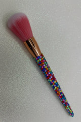 Rainbow  Bling Powder Brush with a full multicolored crystal handle, gold ferrule and pink bristles by La Paz Cosmetics on a white background 
