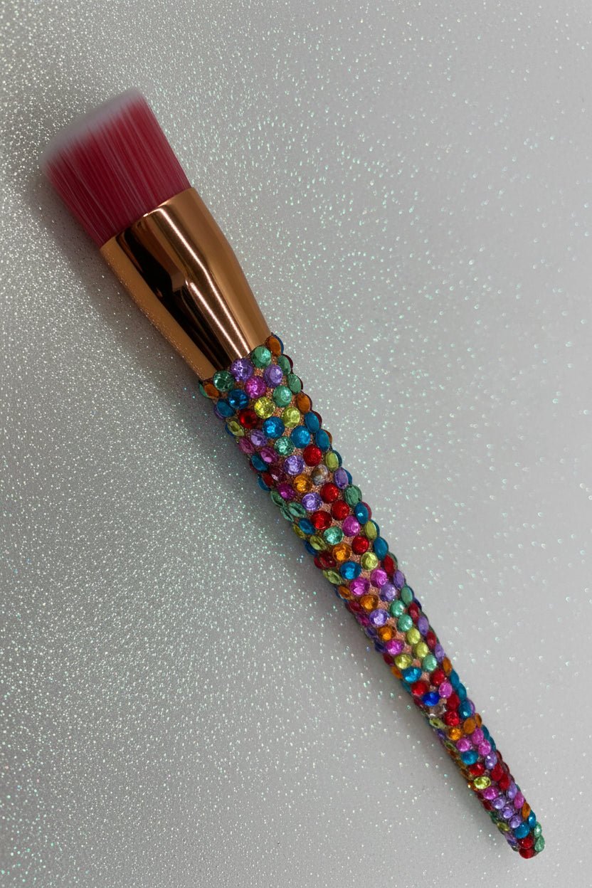 Rainbow  Bling Stippling Brush with a full multicolored crystal handle, gold ferrule and pink bristles by La Paz Cosmetics on a white background 
